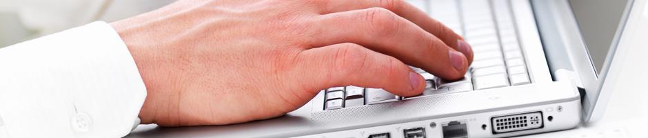 Close-up portrait of a man's hands working on computer